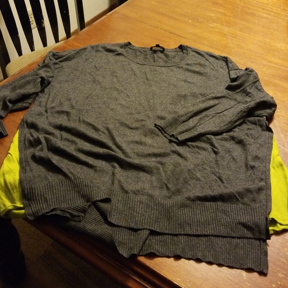 Grey sweater with bright green side slits.